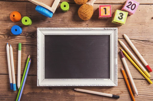 Empty picture frame and toys — Stock Photo, Image