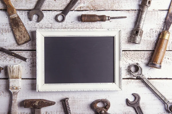 Empty picture frame and work tools. — Stock Image Empty picture frame and work tools. Stock Photo
