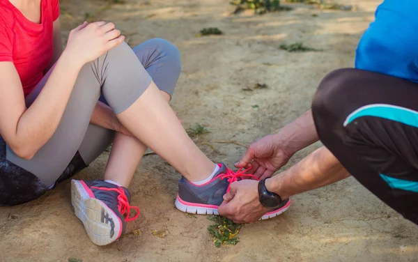 Young runners tying shoelaces.