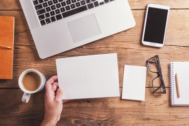 Office desk with blank sheet of paper.