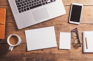 Office desk with blank sheet of paper.