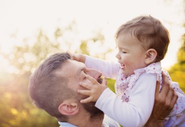 Happy father with his daughter having fun