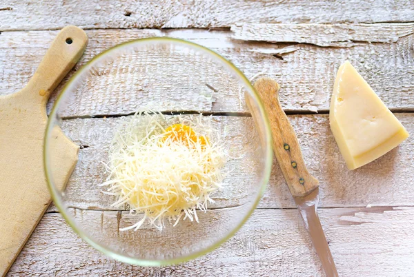 Eggs and cheese in a glass bowl. — Stock Photo, Image