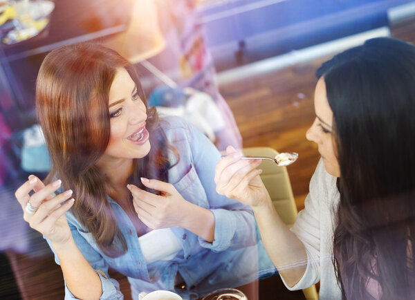Two women having fun in a cafe