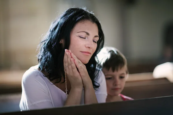 Woman with her son praying — Stock Photo, Image