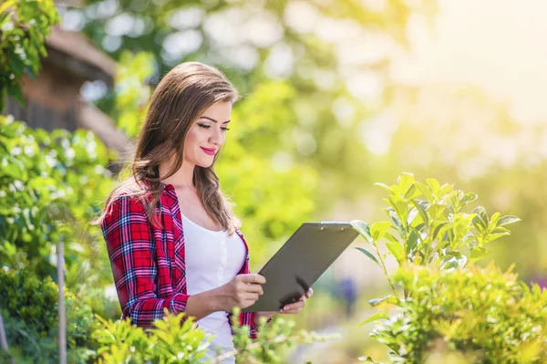 Schöne junge Frau bei der Gartenarbeit — Stockfoto