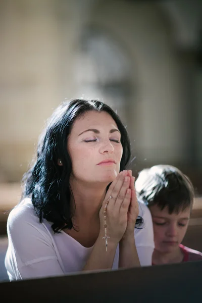 Woman with her son praying — Stock Photo, Image