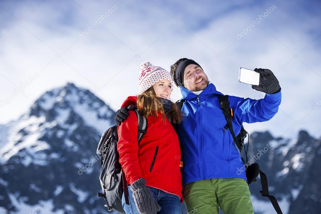Young couple taking selfie on a hike