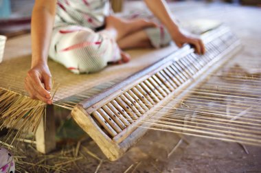 Vietnamese woman weaving a mat clipart