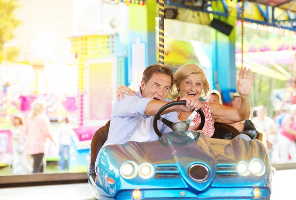 Senior couple at the fun fair — Stock Photo, Image