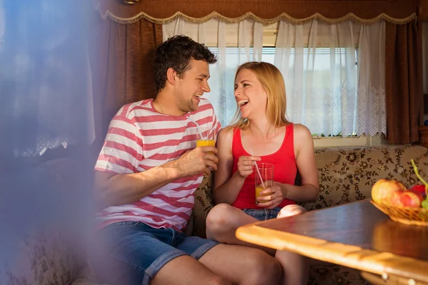 Young couple sitting in a camper van — Stock Photo, Image