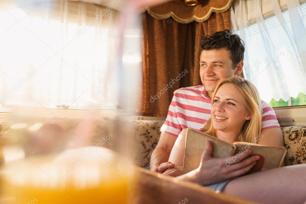 Young couple sitting in a camper van