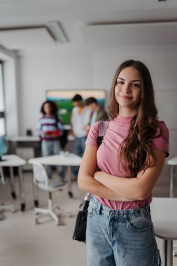 Modern sınıfta duran kendinden emin genç kız öğrenci..