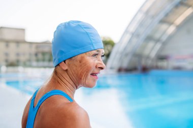 Yaşlı bayan yüzücü normal fitness yüzüşüne hazırlanıyor. Yaşlı sağlık hizmetleri.