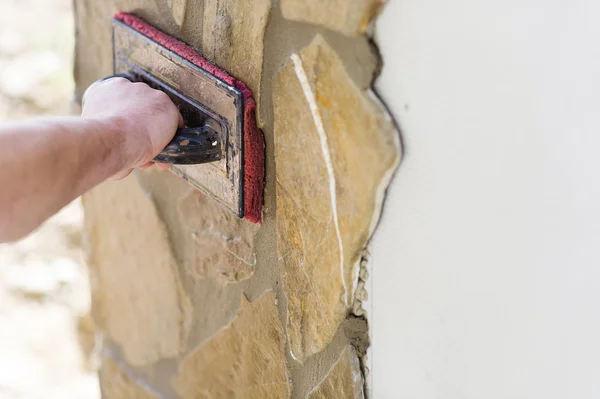 Builder putting stones on wall — Stock Photo, Image