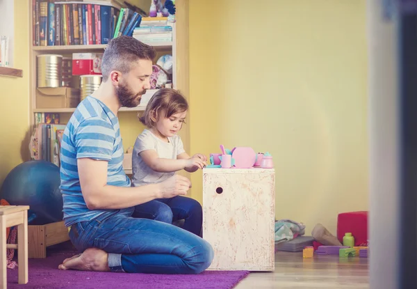 Father and daughter playing at home — Stock Photo, Image