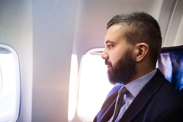 Businessman traveling in airplane — Stock Photo, Image