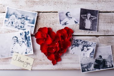 Photos of a couple in love. Red rose petal heart.