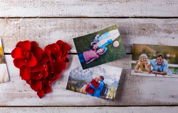 Photos of a couple in love. Red rose petal heart. — Stok fotoğraf