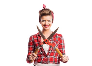 Woman with pin-up make-up and hairstyle holding pruning shears