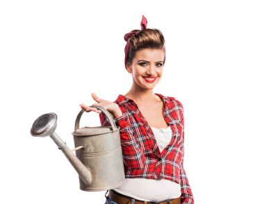 Woman with pin-up make-up and hairstyle holding metal watering c
