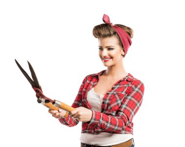Woman with pin-up make-up and hairstyle holding pruning shears