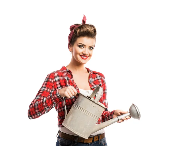 Woman with pin-up make-up and hairstyle holding metal watering c — Stockfoto