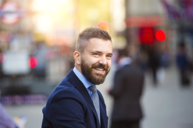Hipster manager in the crowded street of London, Piccadilly Circus