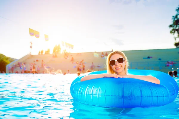 Woman in inflatable ring in pool. Sunny summer and water. — Stok fotoğraf