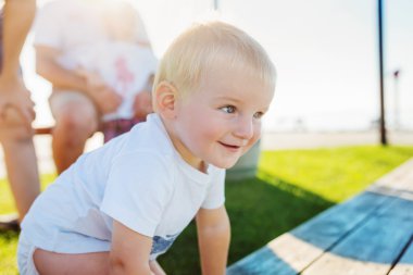 Little boy outside in sunny summer nature