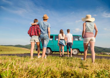 Couples in love, nature, blue sky, campervan, back view