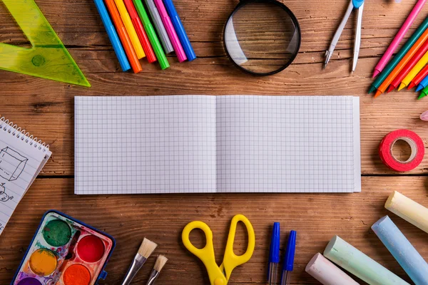 Desk, school supplies, squared paper, wooden background, copy sp — Stock Photo, Image