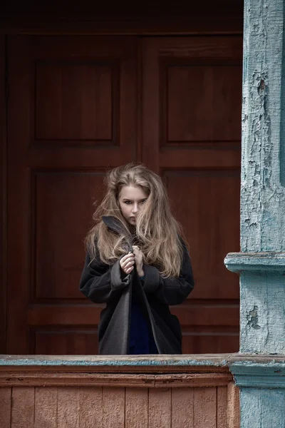 Beautiful blonde woman in a light gray coat. — Stock Photo, Image