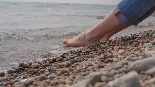 Mädchen sitzt am Ufer des Baikalsees. — Stockvideo