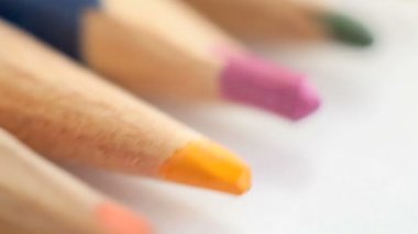 Beyaz kağıt üzerine renkli ahşap kalemler