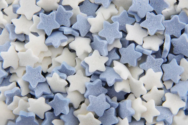Blue and white sugar stars cake decorations — Photo