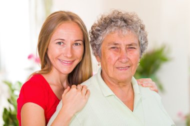 Elderly woman and her daughter clipart