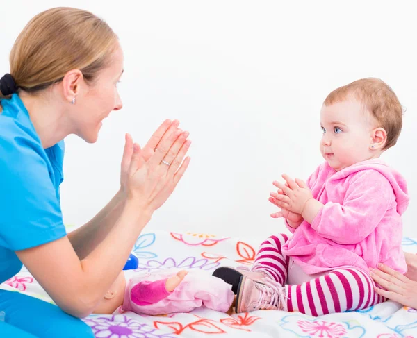 Adorable baby with babysitter — Stock Photo, Image