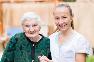 Elderly woman with caregiver clipart