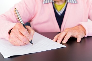 Elderly woman writing