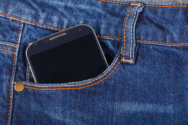 Mobile phone and blue jeans