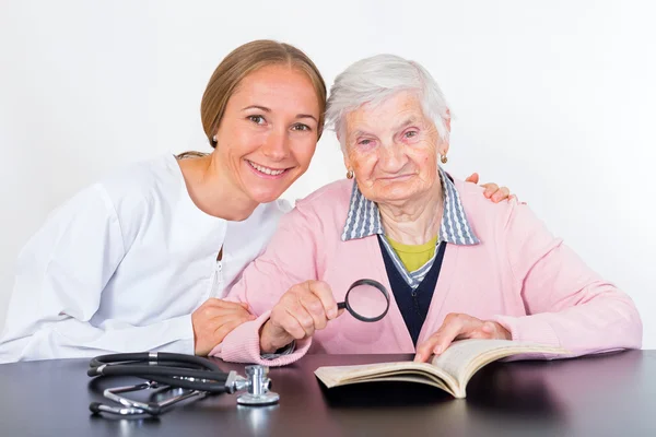 Elderly woman and young doctor — Stock Photo, Image