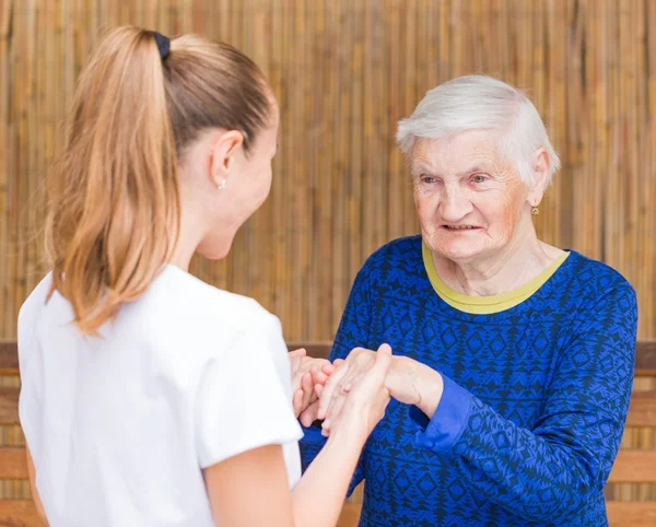 Foto de anciana con su cuidador — Foto de Stock