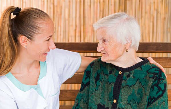 Elderly woman with caregiver