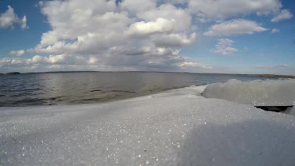 Topniejący lód na jeziorze w cieplejsze dni. Wiosna nad jeziorem. Upływ czasu — Wideo stockowe