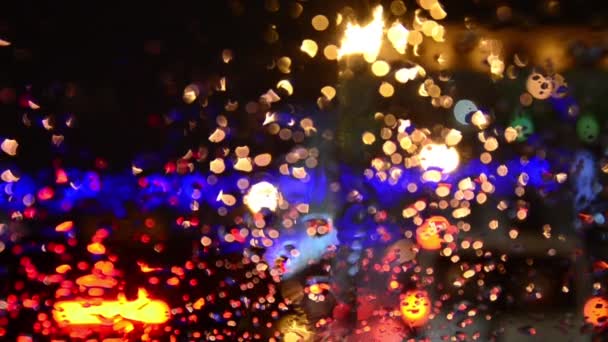 Defocused lights. Driving on a rainy highway, cars braking. Rain on windshield. — Stock Video