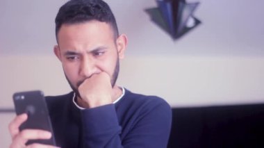 Yakın plan üzgün adam ev telefonunda kötü haber okuyor.