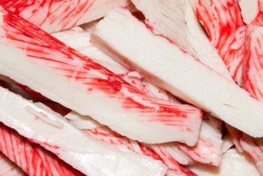 Yengeç çubuğu. Yengeç etinin arka planı. Beyaz balık etinden yapılmış yengeç çubukları..