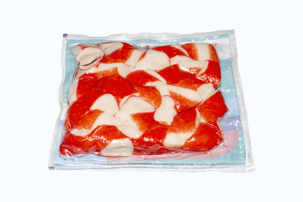 Crab meat in a package on a white background.Crab meat made from white fish.