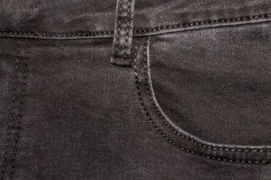 Siyah renkli kumaş kumaş dokusu. Siyah kot pantolonun arka planı. Arka planı cepli siyah kot..